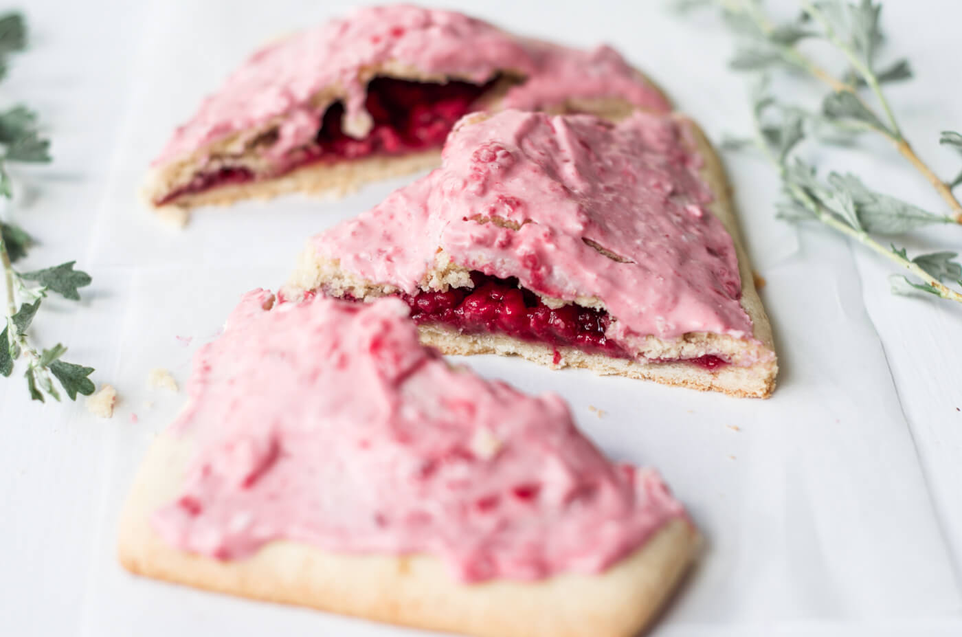 Easy to make paleo raspberry pop tarts are so full of flavor, naturally sweetened, and grain free. These delectable breakfast tarts have a delicious flaky crust (that doesn't crumble) and are filled with sweet berry filling. Gluten free and healthy!