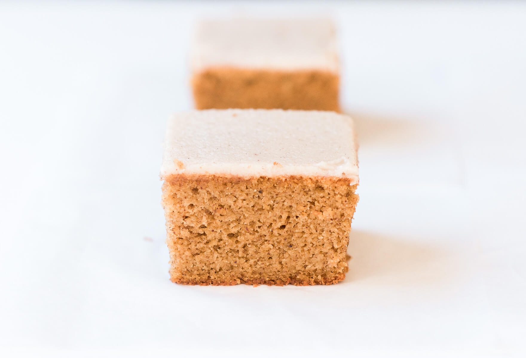 Grain free, gluten free, healthy, paleo, protein packed pumpkin cake with vegan maple frosting- no refined sugar! Soft, light, perfect for a fall dessert or healthy paleo snack. Easy Pumpkin Breakfast Cake.