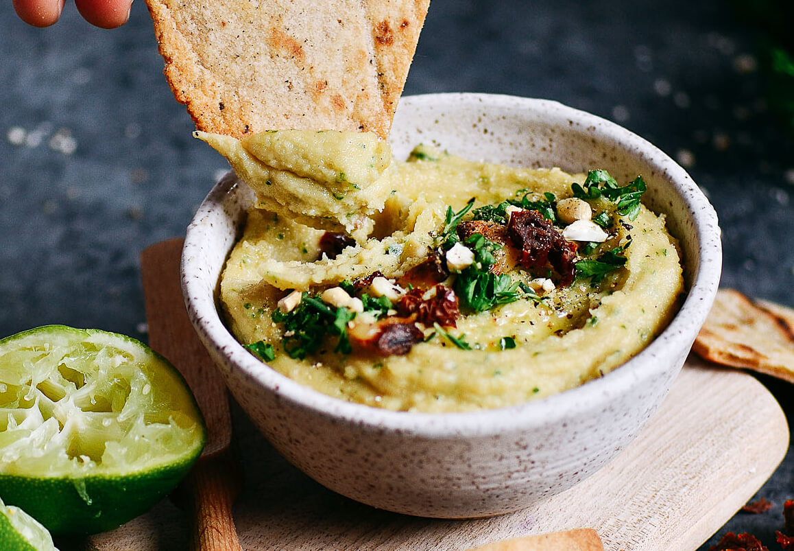 5 minute garlic lime cashew hummus is made without beans (gasp!). Made with soaked cashews, garlic, lime, parsley. Deliciously creamy, smooth, and full of flavor! Whole30 and paleo friendly. Served with paleo cassava flour pita chips! Whole30 hummus. Whole30 snacks. Paleo hummus. Paleo Snacks. easy cashew hummus dip. Hummus dip. best healthy hummus. Easy hummus recipe. Garlic lime hummus recipe.