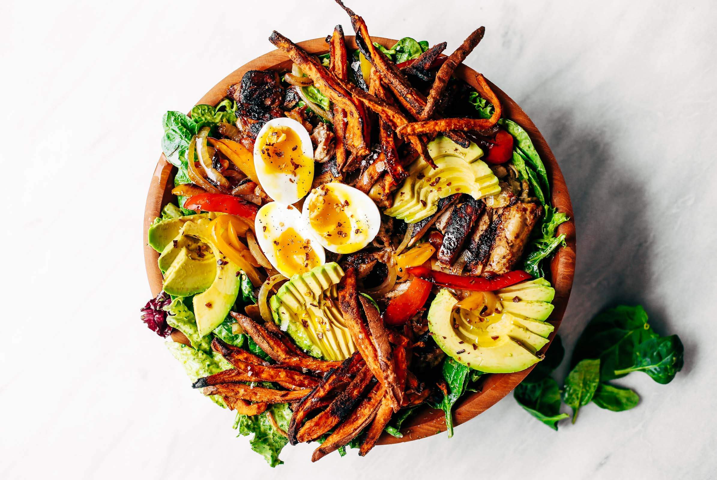 Grilled Garlic Lime Chicken Fajita Salad loaded with crispy sweet potato fries, grilled chicken, and topped with creamy avocado dressing made in the blender! Paleo, whole30, and makes for easy meal prep! Whole30 meal plan that's quick and healthy! Whole30 recipes just for you. Whole30 meal planning. Whole30 meal prep. Healthy paleo meals. Healthy Whole30 recipes. Easy Whole30 recipes. Best paleo dinner recipes.