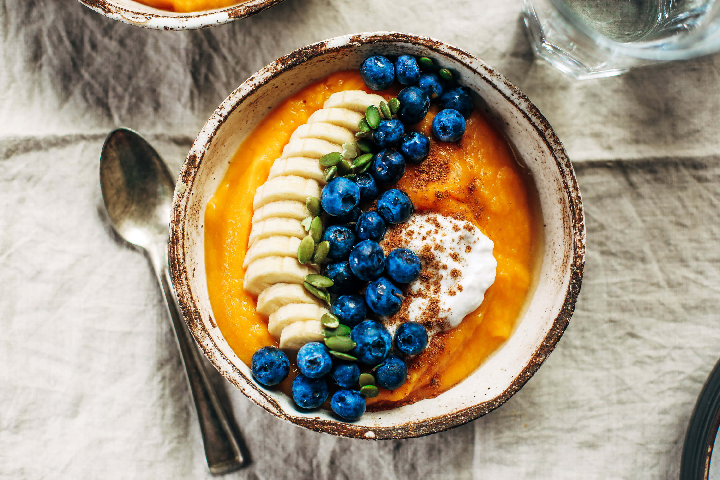 Paleo whole30 breakfast bowl made with butternut squash. Topped off with blueberries, bananas, and pumpkin seeds. This healthy breakfast is easy for on-the-go lifestyles and busy families. Plus, it tastes amazing and will leave you wanting more! #paleo #recipes #cooking #whole30